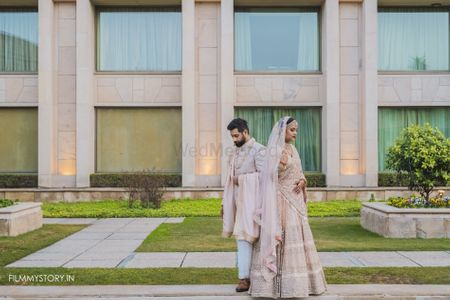 pastel bride and groom in matching light pink outfits 