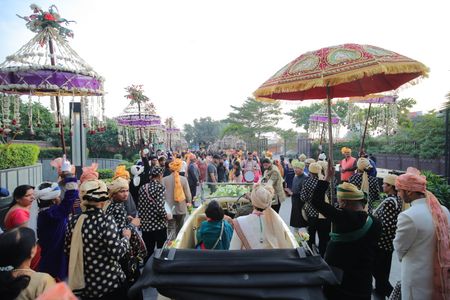 Photo of baraat photo with groom entering in an open top car