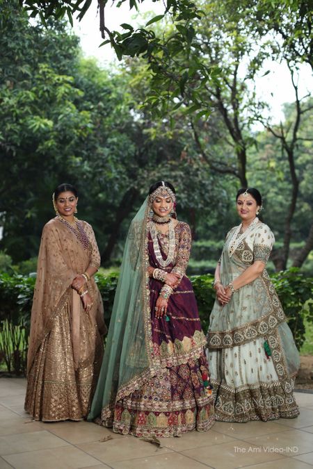 bride in unique lehenga with mother and her sister
