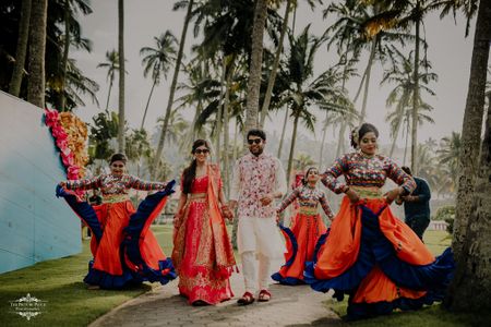 Photo of bride and groom entering together with professional dancers.