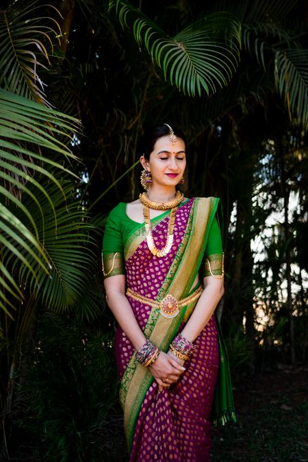 A south Indian bride dressed in purple and green saree