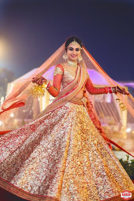 Bride Wearing Gold Sequin Work Lehenga with Red Blouse