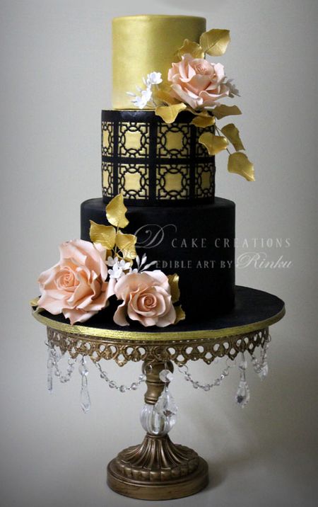 glamorous cocktail cake in black and gold with lace effect and pale pink roses with gold leaves
