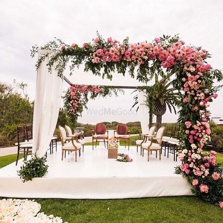 A gorgeous pink floral mandap by the seaside.