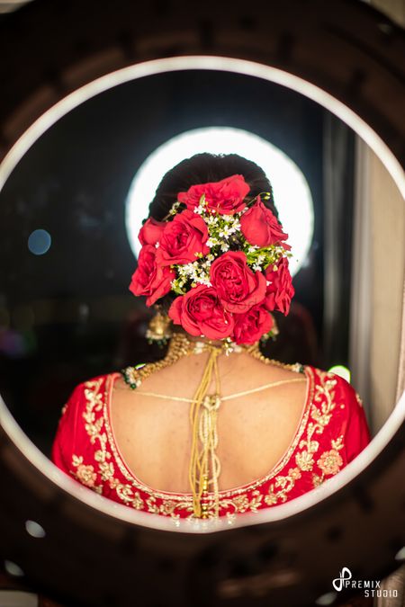 Photo of red bridal bun with big full roses