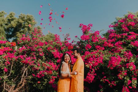 matching bride and groom in happy haldi photo