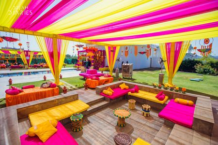 Photo of Pink and yellow themed mehendi decor.