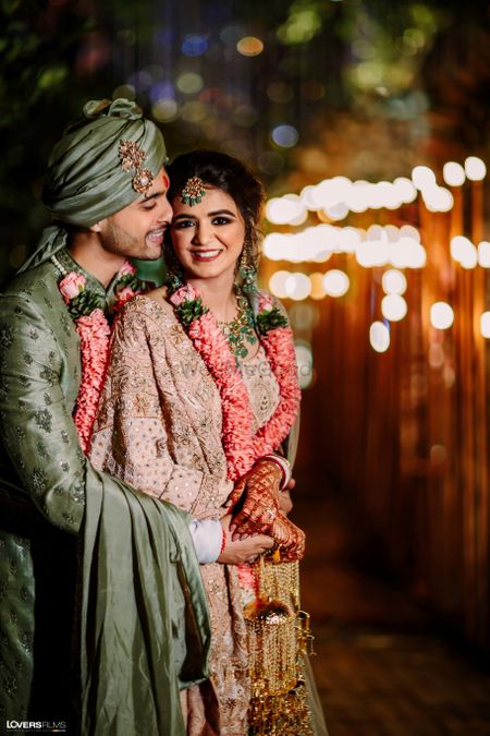 Photo of pretty bride and groom shot with groom in grey sherwani