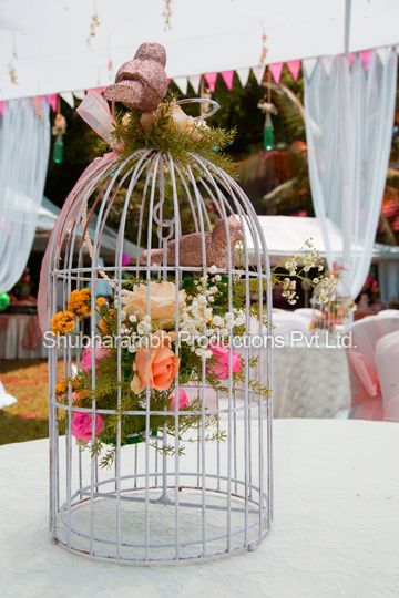 Photo of birdcage with roses inside