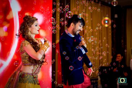 Photo of Guests Blowing Bubbles while Bride and Groom Perform
