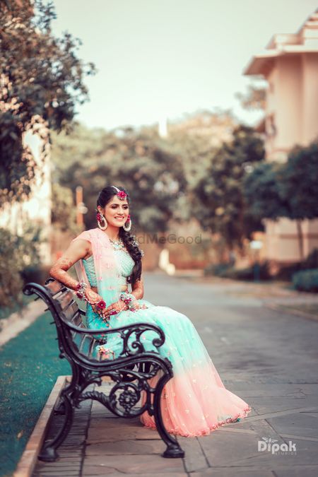 Bride wearing a dual-toned lehenga with floral jewellery.