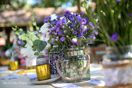 Photo of Mason jars filled with flowers used as a centrepiece.