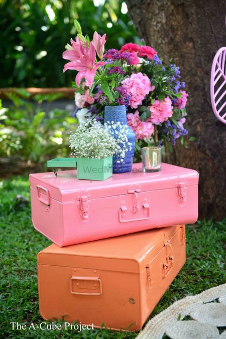 Hand-painted trunks with floral arrangements.
