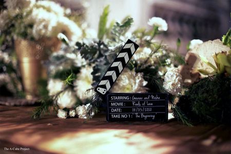 Clapper boards and flowers used as a table centerpiece.