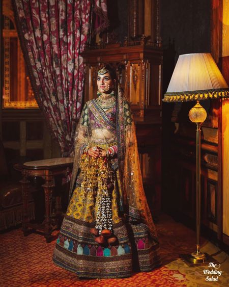 Photo of multicolour sabyasachi bridal lehenga with unique kaleere