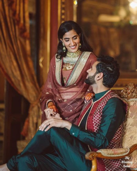 Photo of matching bride and groom in outfits for the mehendi