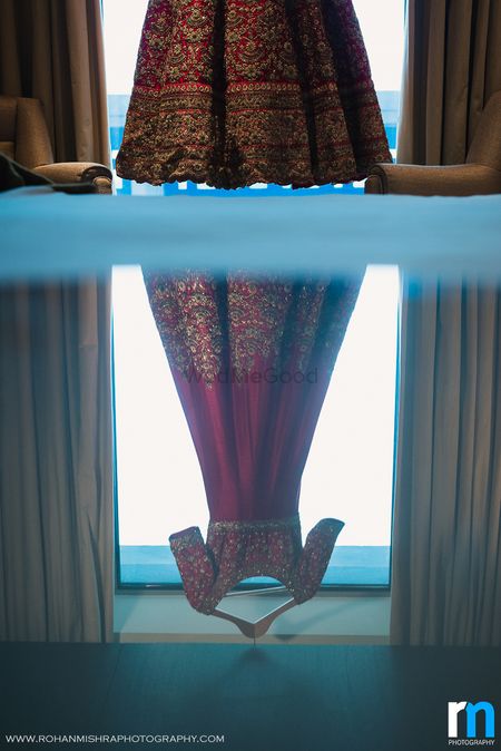 Reflection of Maroon Bridal Anarkali on Hanger