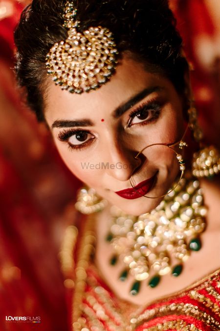 bridal makeup with red lehenga with deep red lips 