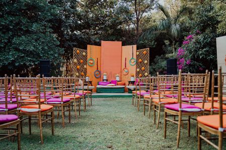 Photo of simple stage and chair decor with peach and pink theme