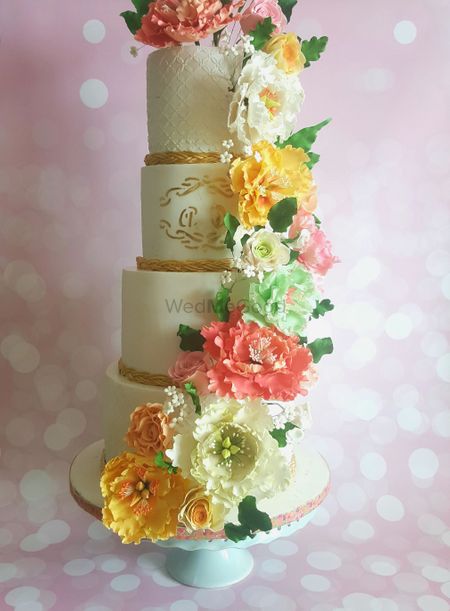 Photo of 4 Tiered Multicolour Wedding Cake with Flowers
