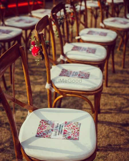 Photo of wedding programs placed on chairs for outdoor wedding