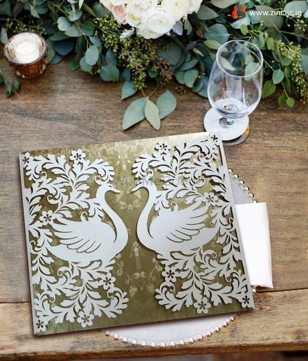 Photo of White Laser Cut Invite with Swan Pattern