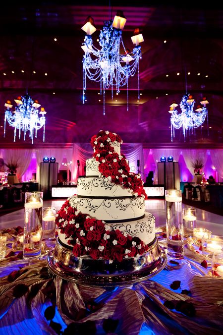 Photo of Five-tier wedding cake with flower arrangement.