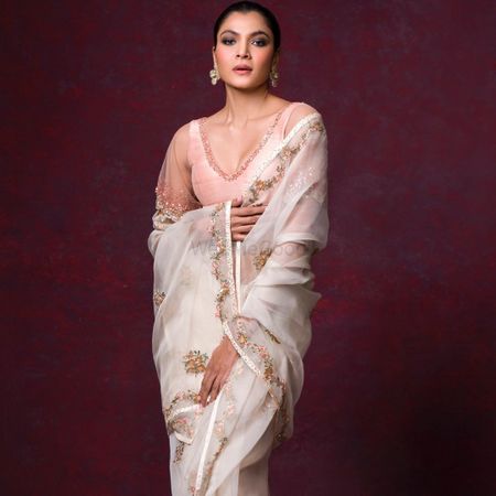 Ivory saree with a pink blouse.