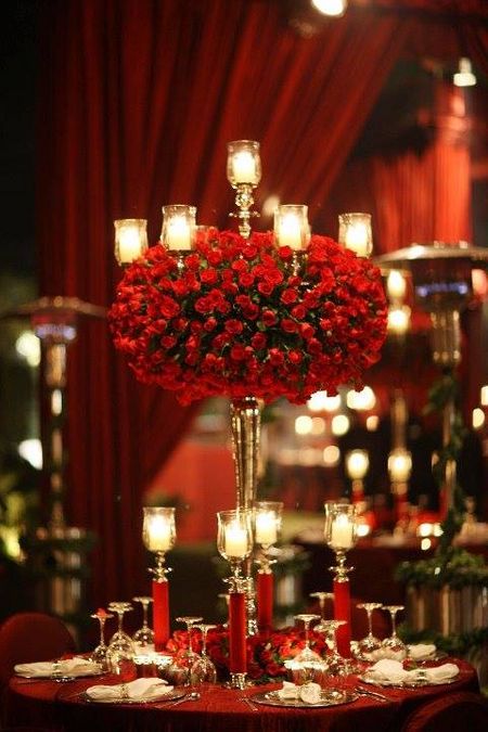 Photo of table centerpieces with roses and candles