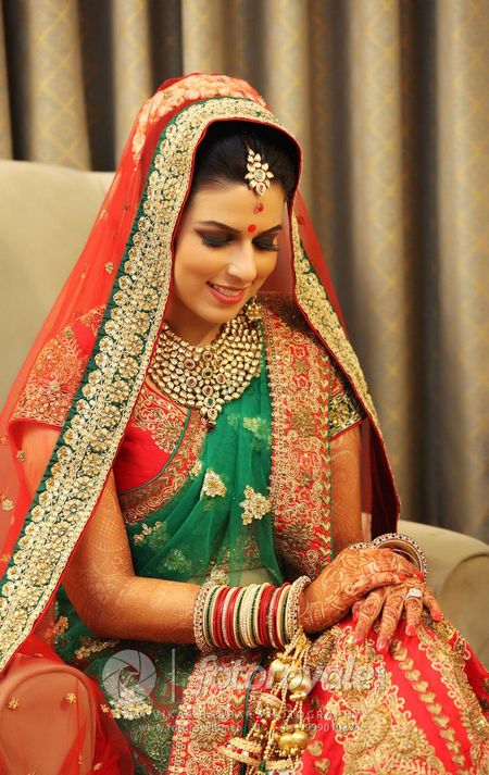 Punjabi Bride in Red and Teal Bridal Lehenga