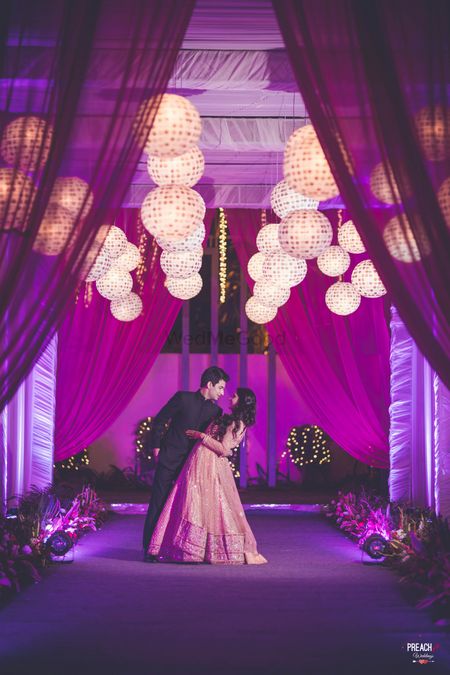 Photo of Purple Entrance Decor with Drapes and Round Paper Lamps