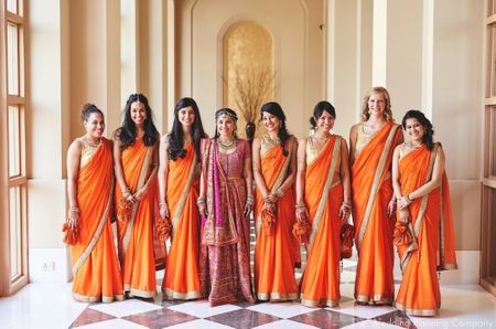 Photo of Bride with Matching Bridesmaids in Orange Sarees