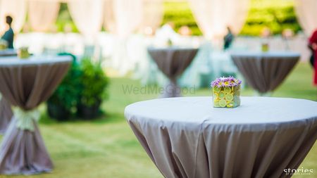 grey cocktail table setting with stand up tall tables