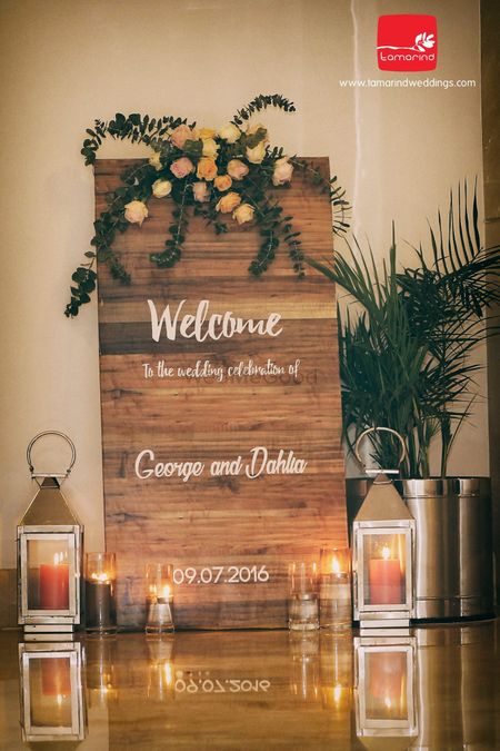 Photo of Entrance Wedding Decor with Wooden Welcome Board