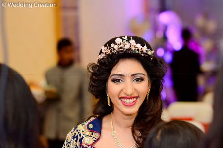 Open hairstyle with studded hair wreath for sangeet