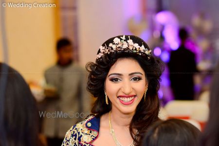 Open hairstyle with studded hair wreath for sangeet