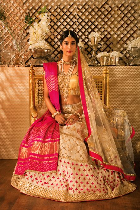 Photo of White and Pink Bridal Lehenga with Gold Blouse