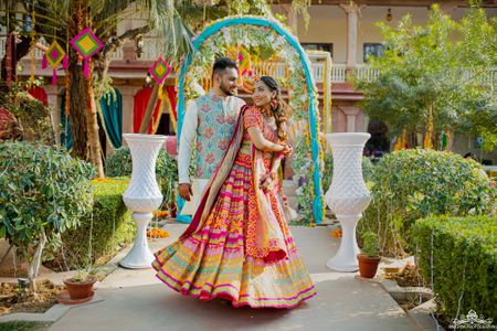 Bride and groom dressed in vibrant outfits.