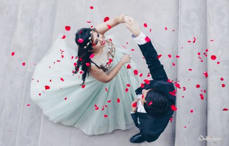 Couple dancing shot with rose petals being showered