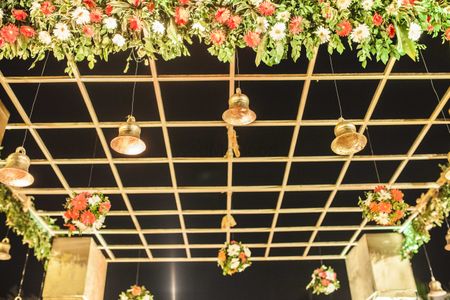 Photo of Gold Temple Theme Mandap with Bells and Flowers