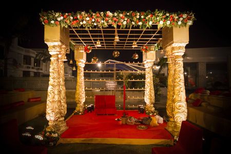 Photo of Gold Temple Theme Mandap with Jali and Flowers