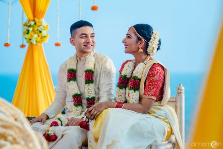 Candid shot of South Indian bride and groom looking at each other.