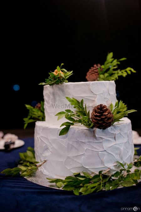 Two-tiered cake decorated with leaves.