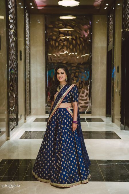 Navy blue lehenga with gold motifs and border