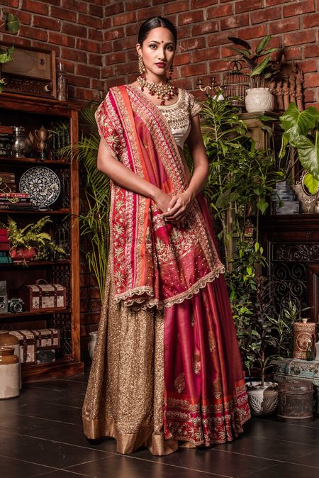 Photo of Red and gold saree draped as lehenga
