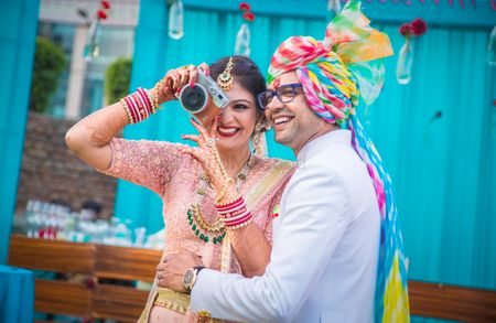 Couple portrait with bride holding camera