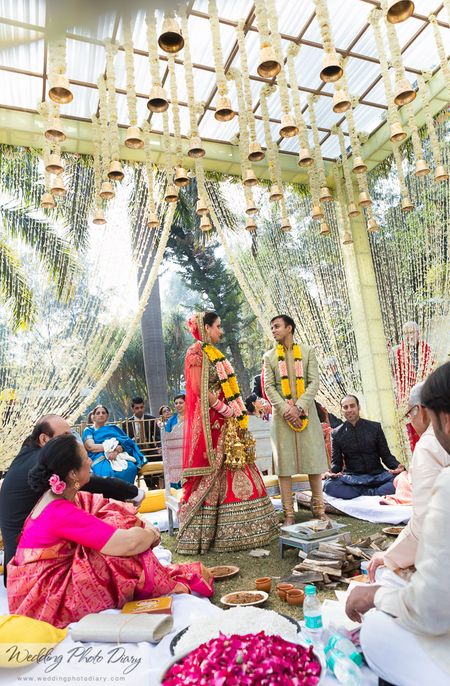 Mandap with hanging flower strings and temple bells
