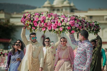 Bridal entry under a voluminous phoolon ki chaadar.