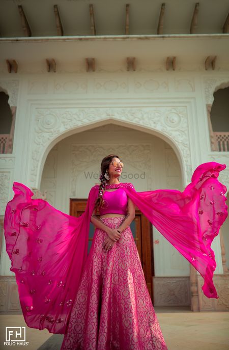 The bride dressed in a banarasi lehenga with a cape-sleeved blouse.