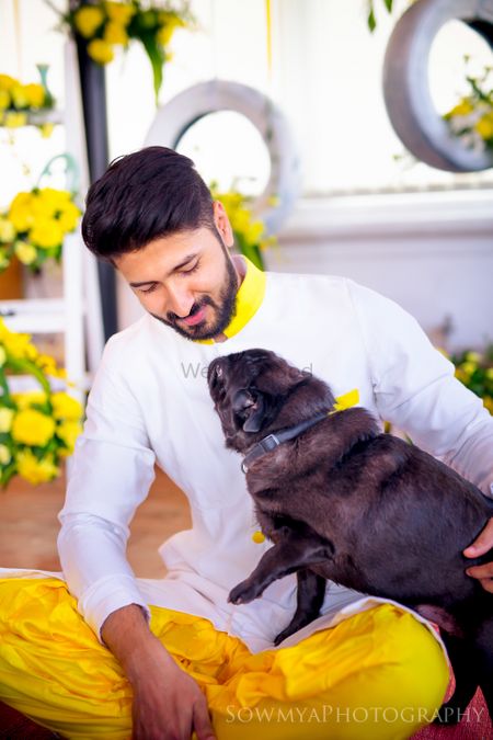 Photo of groom with dog candid shot